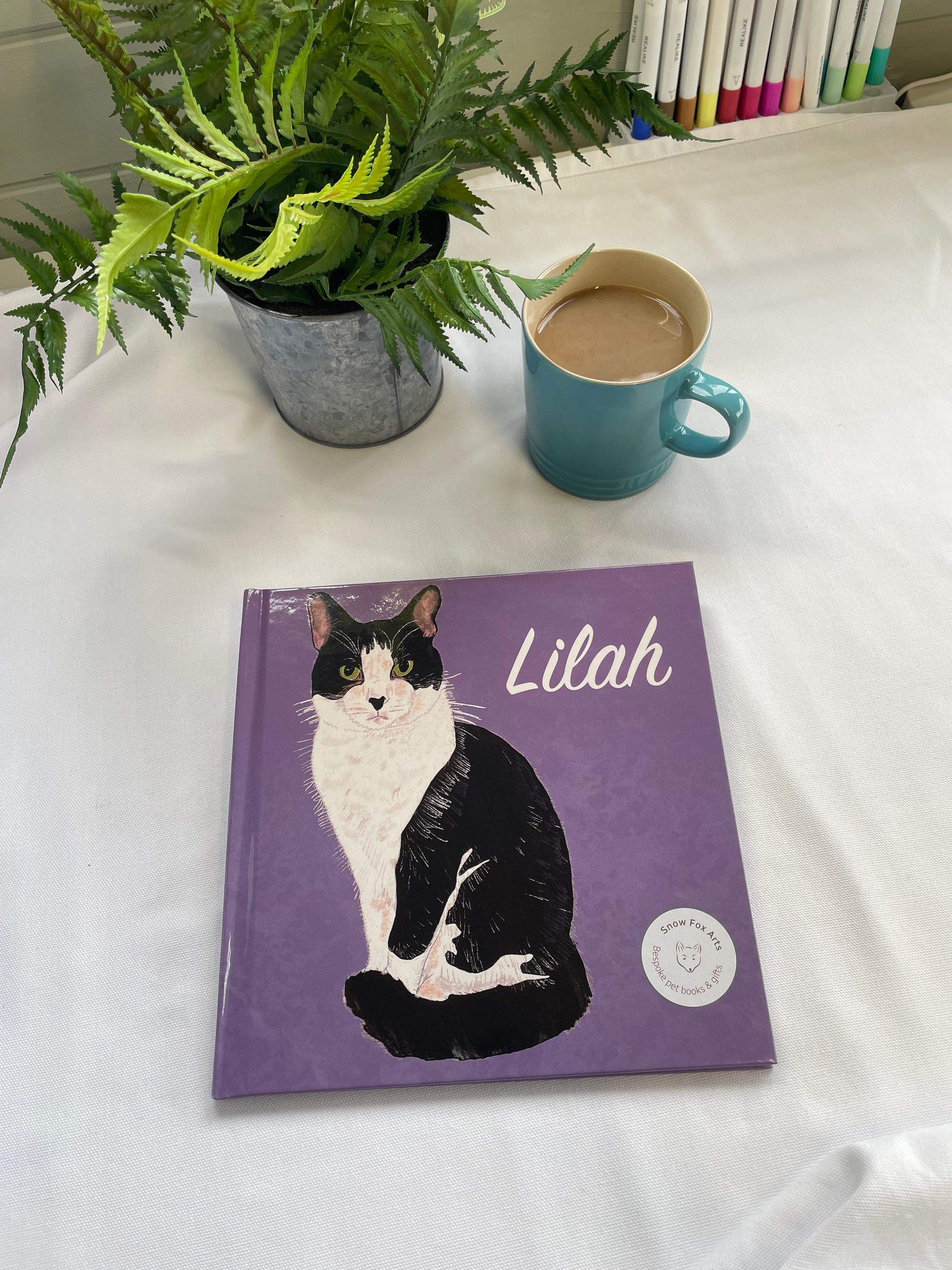 Custom Pet Memory Book Example Cover | Snow Fox Arts | A cat on a purple background labelled Lilah