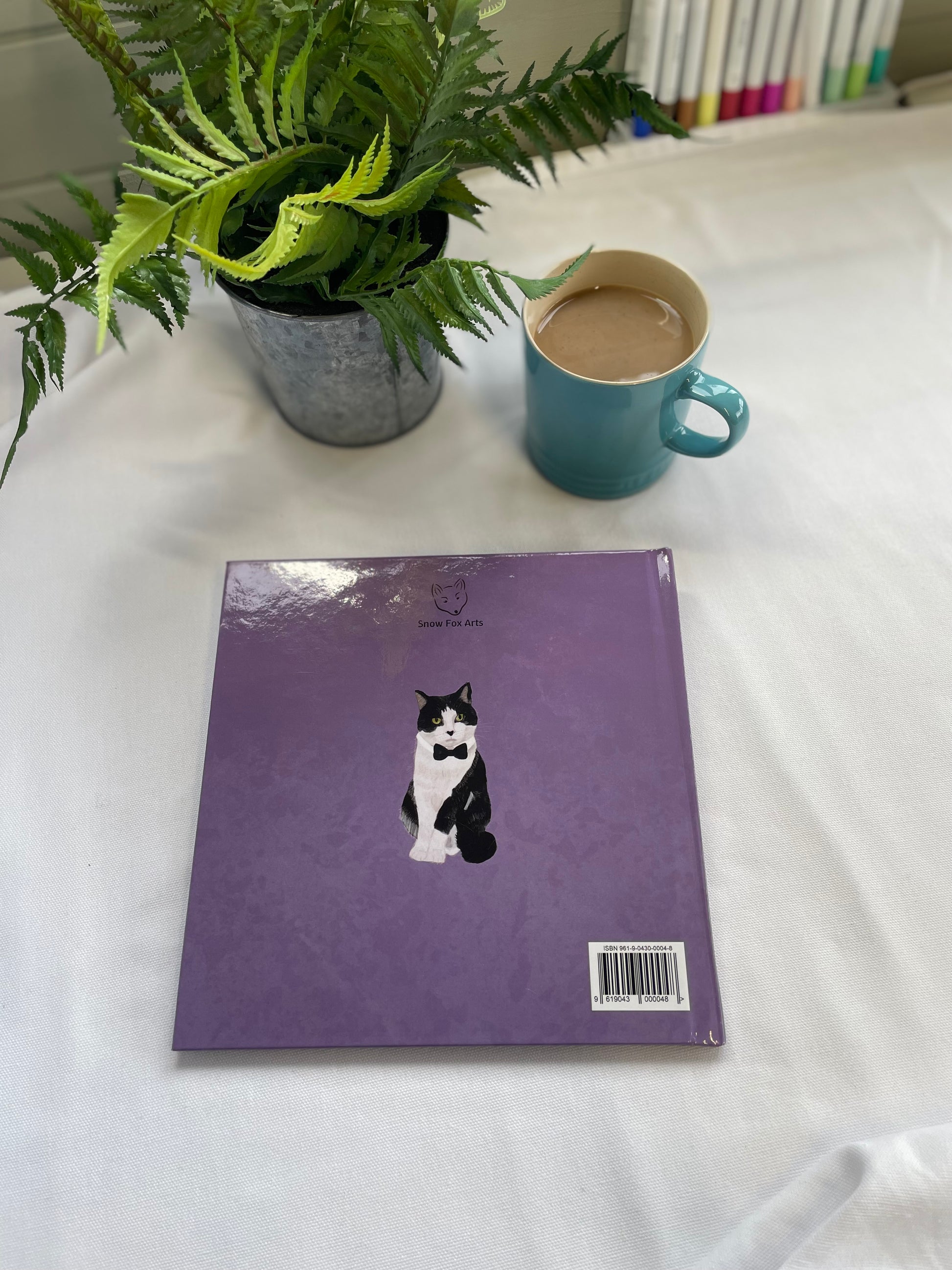Example Back Cover Custom Pet Memory Book | Snow Fox Arts | Book cover shows an image of a cat in a bowtie on a purple background.